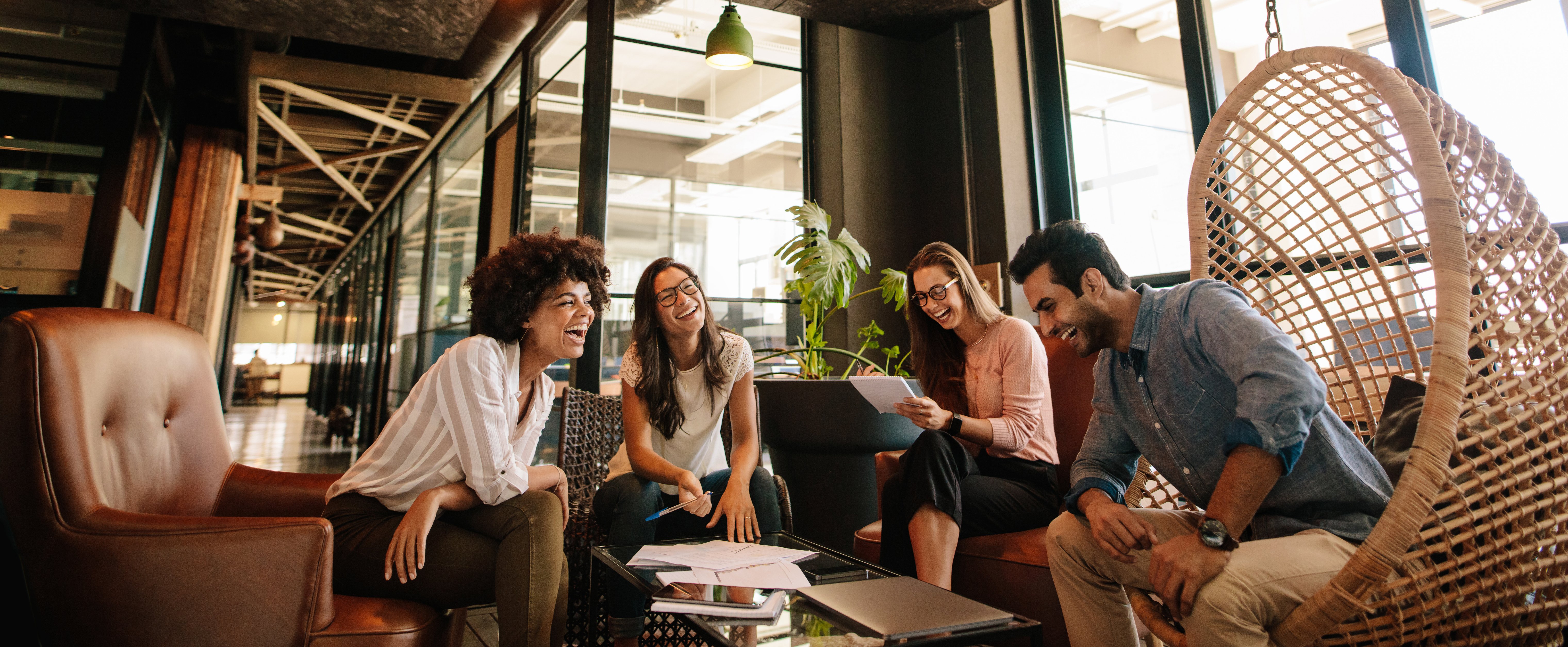 Team laughing around table busy working - Join our team at the Cape Town Real Estate Group powered by eXp Realtors Cape Town  South Africa Article Eide van Zyl